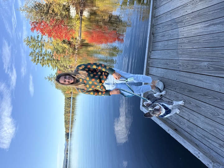 Louie on a lake dock in peak foliage